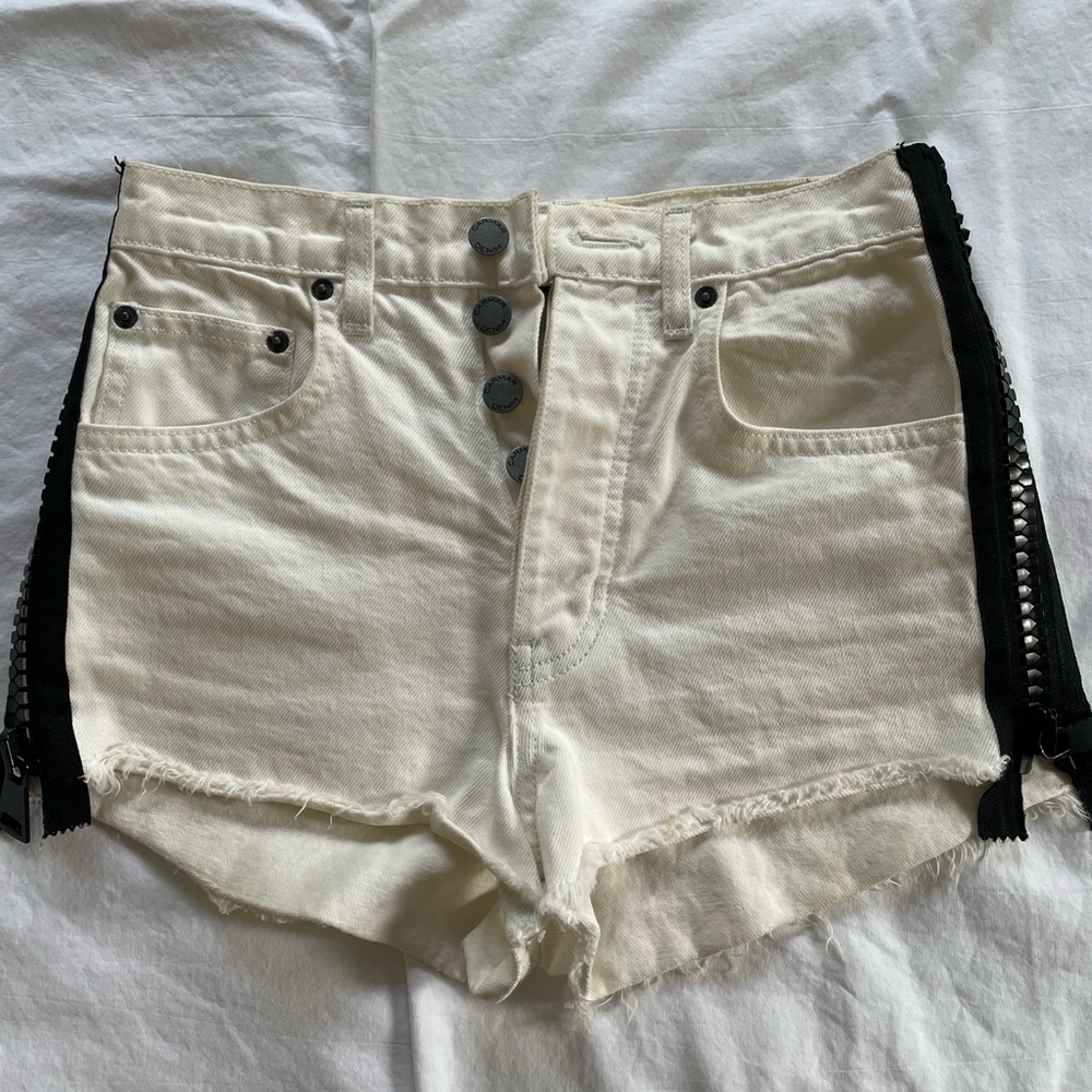 Carmar white jean shorts with a black zipper side detail